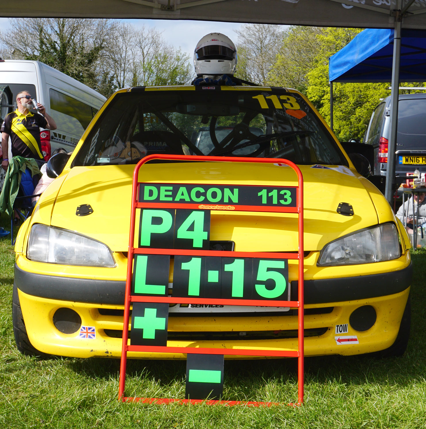 ES racing car parked up with the pit board leaning against the bonnet showing the fastest time of the day